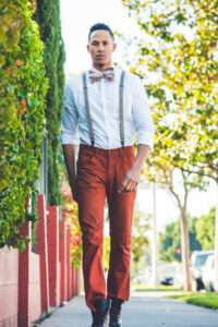 Man walking with bow tie and suspenders on